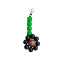Keychain with green, black, and brown beads on a white background